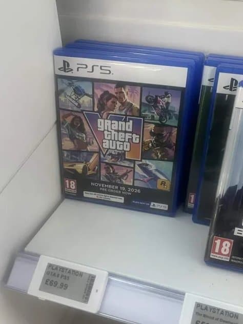A PS5 GTA VI display case on a retail shelf beside a £69.99 price label