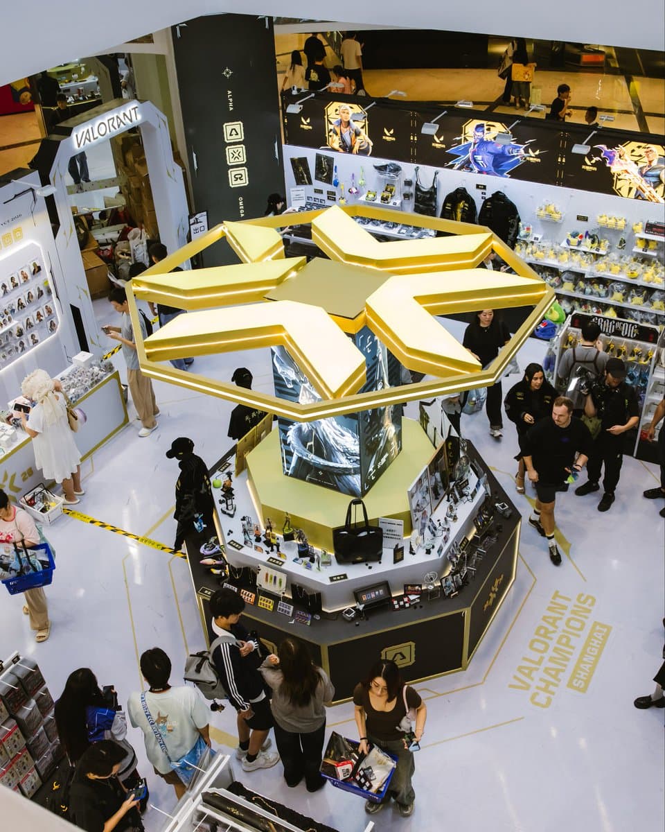 A VALORANT Champions Shanghai retail installation at Jing’an Joy City displays merchandise around a large gold Champions emblem.