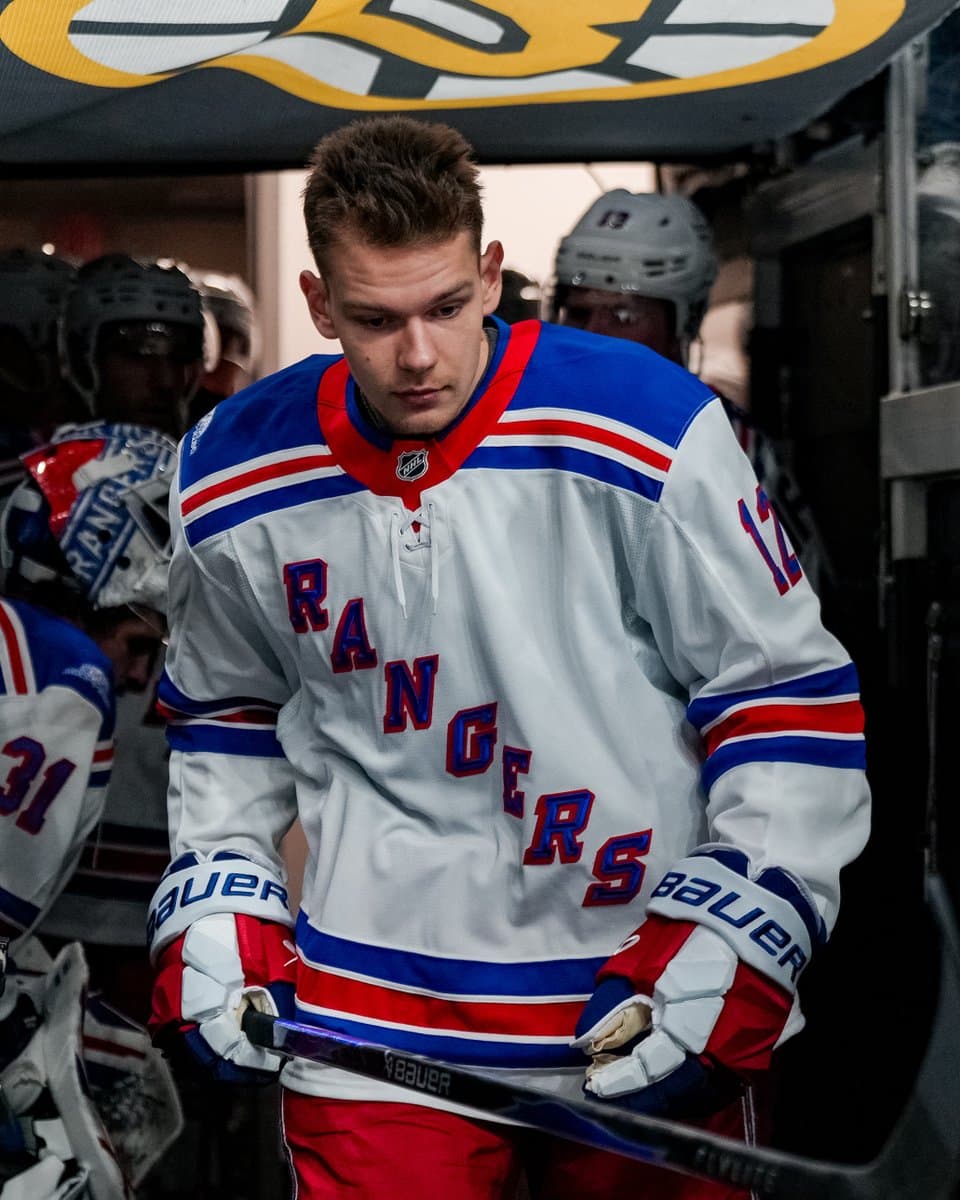 Alberts Smits warming up on ice in a Rangers uniform.